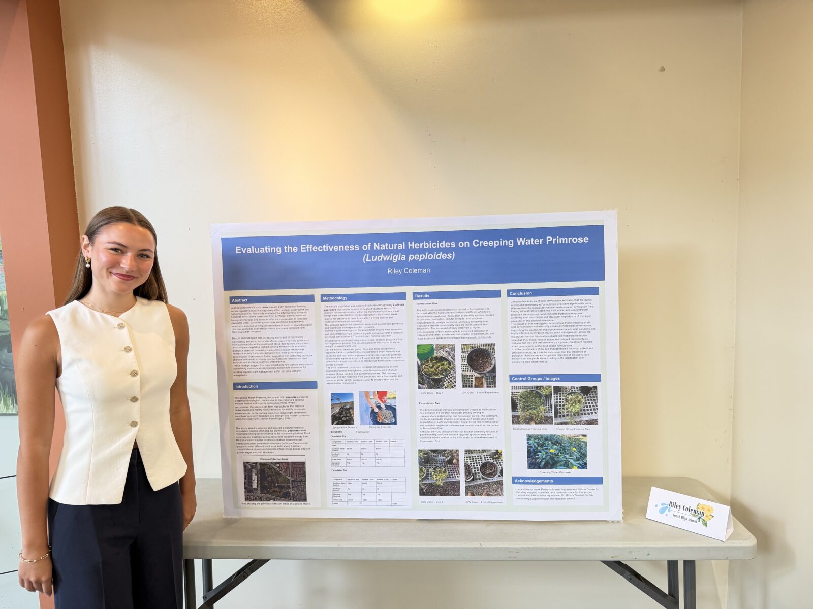 Riley Coleman standing with her Expo display