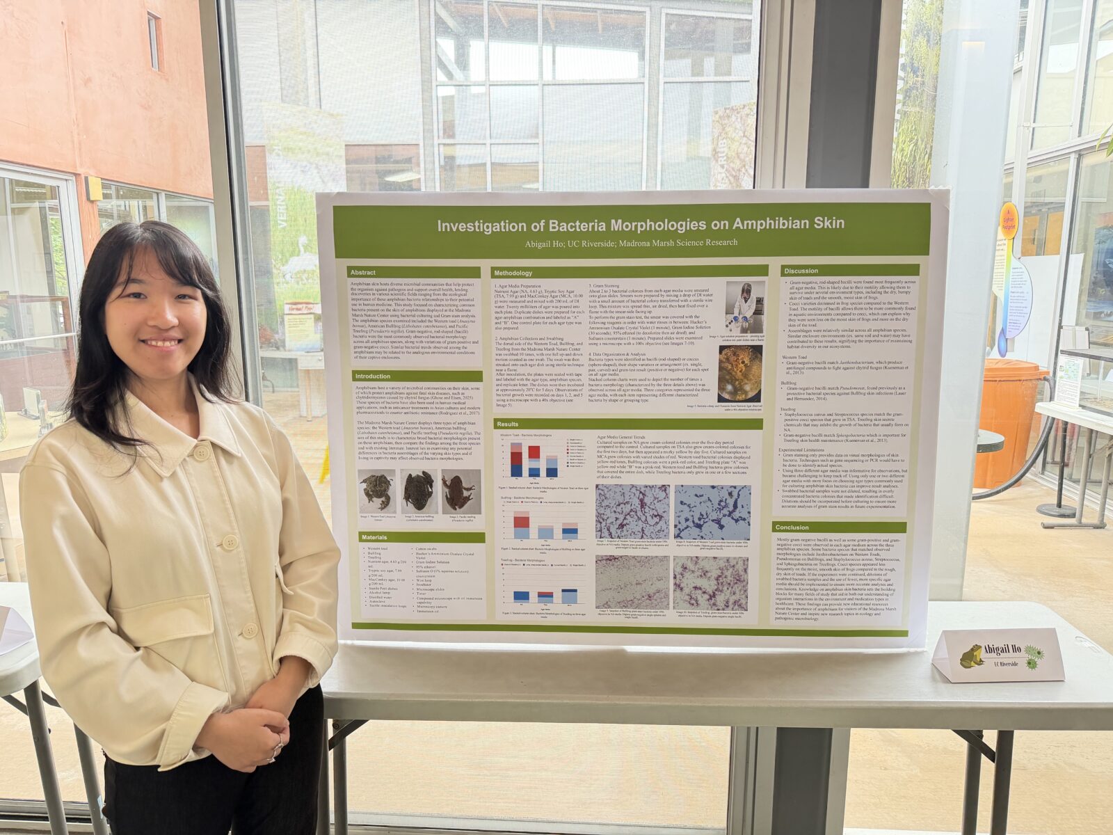 Abigail Ho standing with her Expo display