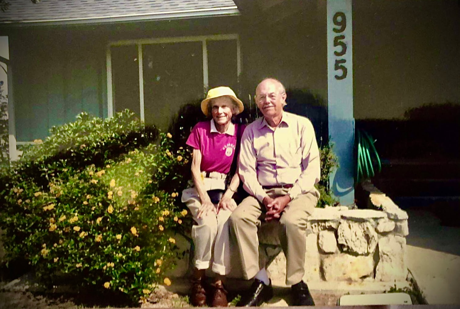 Bart and Kathy Tendick sitting in front of a house